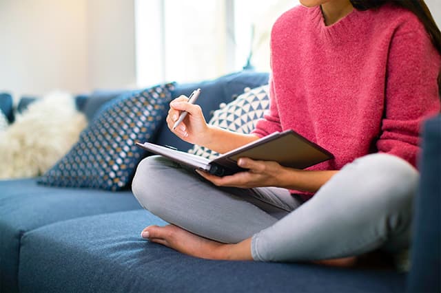 Woman writing down resentments in marriage