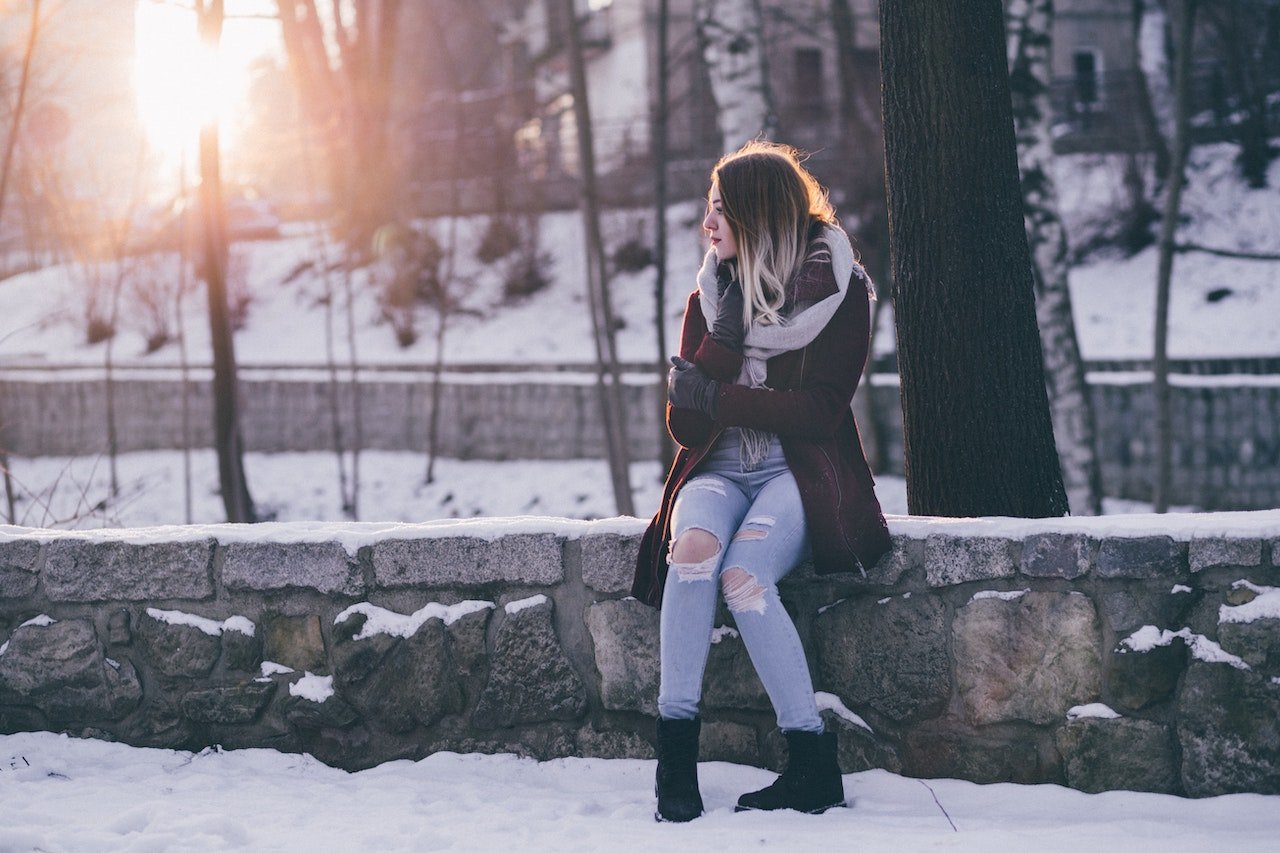 woman-sitting-in-the-park-with-snow- 5 Signs To Tell If Your Crush Likes You